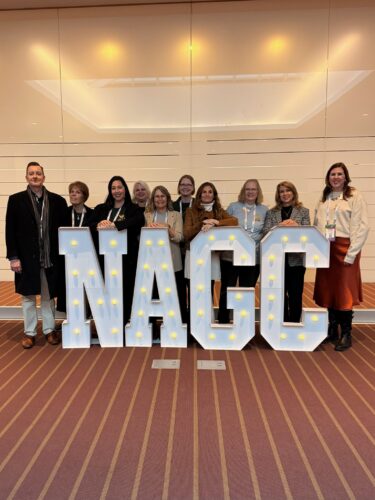 AAGT Board Members arranged behind light up letters spelling out NAGC at NAGC Annual Conference 2025