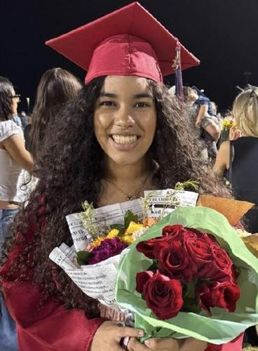 Darianna Castillo at her graduation holding flowers